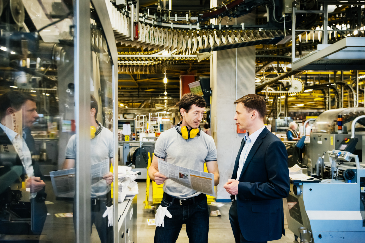 iStock-607469780_Mechanic and Manager talking in huge factory