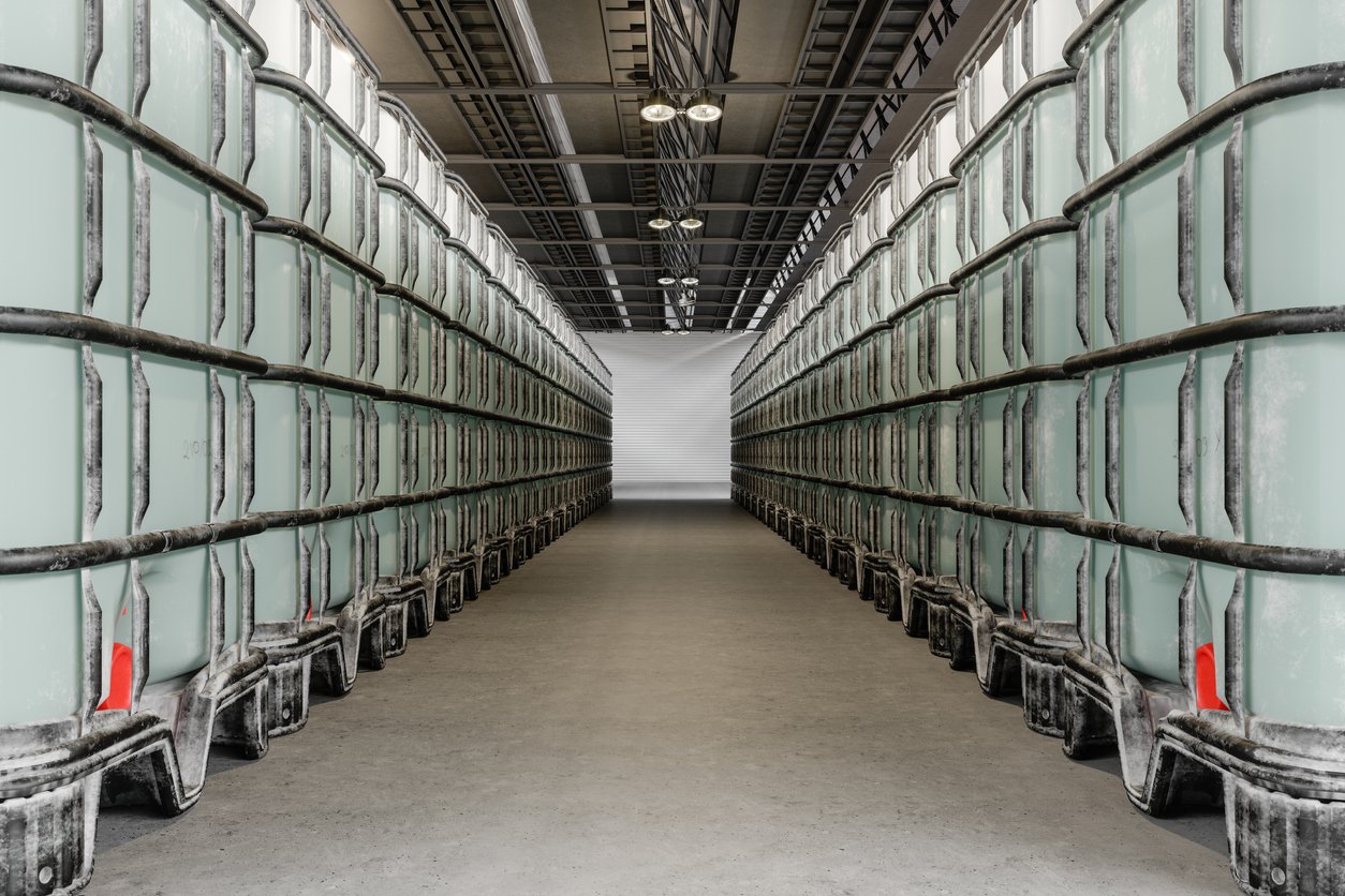 Sodium hypochlorite barrels on metal pallets in a storage room